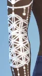 A white ink full-arm sleeve tattoo with sacred geometry and mandala patterns, made for dark skin tones.